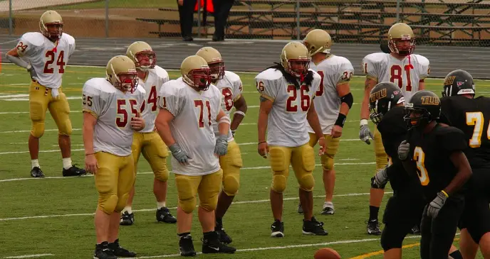 football players lining up in the box on defense